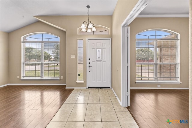 2003 Schottische Ln, Killeen, TX 76542 - entrance foyer with light wood finished floors, a chandelier, baseboards, lofted ceiling, and ornamental molding