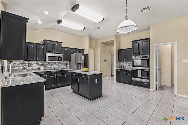 2003 Schottische Ln, Killeen, TX 76542 - kitchen with appliances with stainless steel finishes, dark cabinets, a sink, decorative backsplash, and light tile patterned flooring