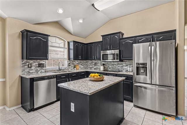 2003 Schottische Ln, Killeen, TX 76542 - kitchen featuring appliances with stainless steel finishes, a sink, vaulted ceiling, light stone countertops, and light tile patterned floors