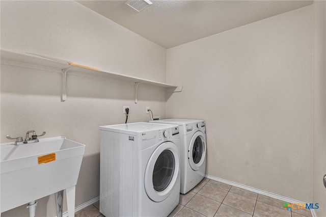 2003 Schottische Ln, Killeen, TX 76542 - washroom with washing machine and dryer, baseboards, and light tile patterned floors