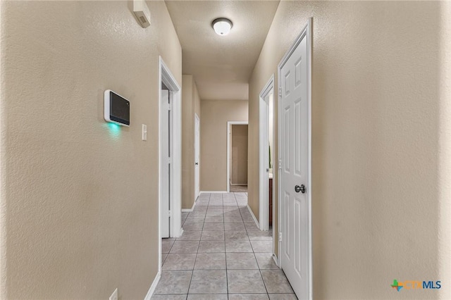 2003 Schottische Ln, Killeen, TX 76542 - corridor with light tile patterned flooring, baseboards, and a textured wall