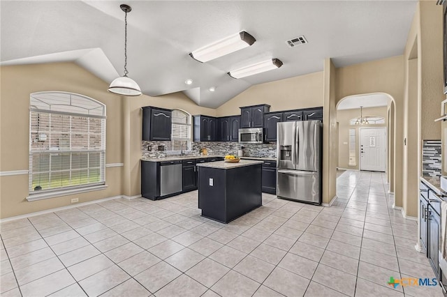 2003 Schottische Ln, Killeen, TX 76542 - kitchen with stainless steel appliances, lofted ceiling, a kitchen island, tasteful backsplash, and light countertops