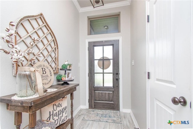 entryway with ornamental molding and wood-type flooring