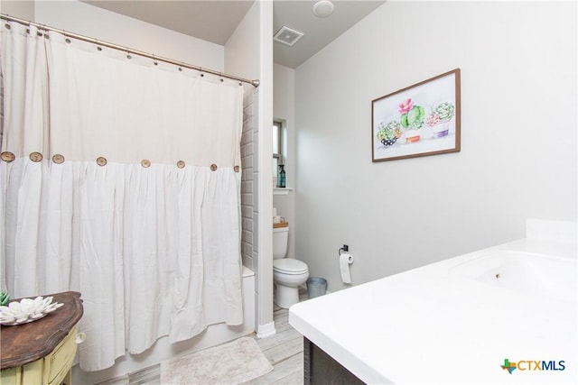 bathroom featuring toilet, vanity, and hardwood / wood-style flooring