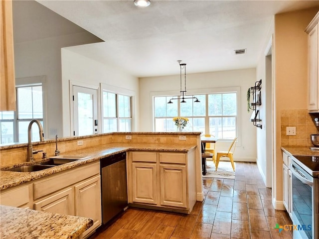 127 Augusta Dr, Wimberley, TX 78676 - kitchen with a sink, dishwasher, hardwood / wood-style flooring, tasteful backsplash, and light stone countertops