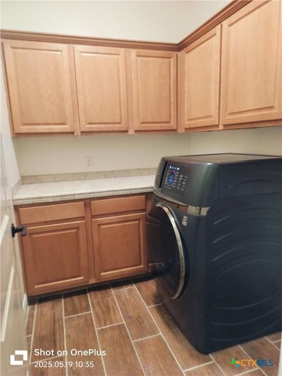 127 Augusta Dr, Wimberley, TX 78676 - clothes washing area featuring cabinet space and wood tiled floors