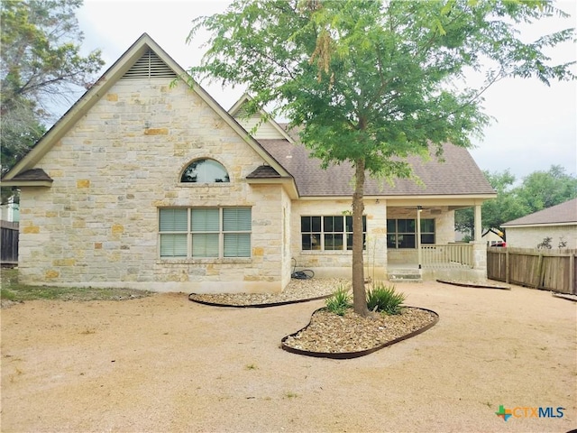 127 Augusta Dr, Wimberley, TX 78676 - back of house with stone siding, fence, a patio area, and a shingled roof
