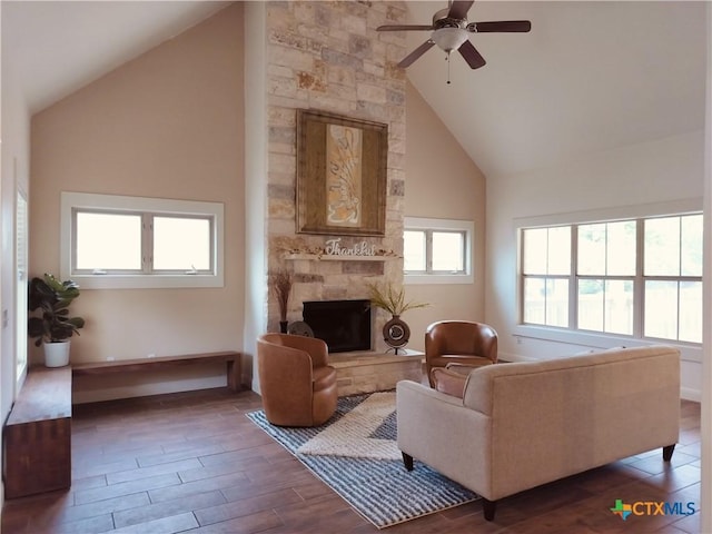 127 Augusta Dr, Wimberley, TX 78676 - living room featuring high vaulted ceiling, ceiling fan, wood finished floors, a fireplace, and baseboards