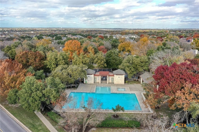 community pool with fence and a patio area