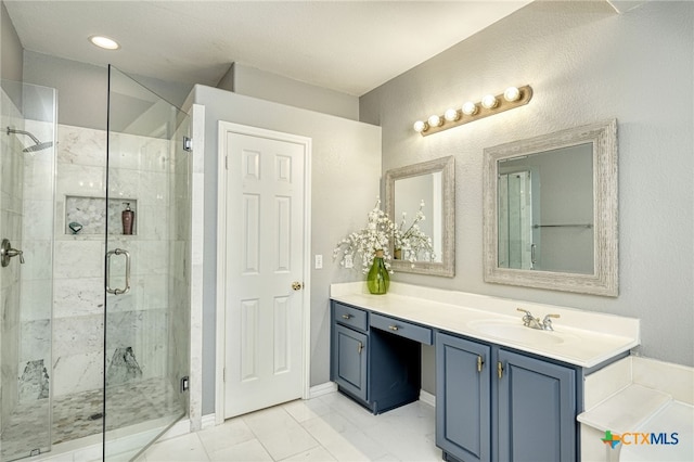 bathroom featuring vanity, marble finish floor, and a shower stall