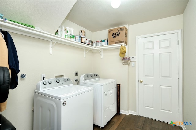 washroom with dark wood finished floors, laundry area, and separate washer and dryer