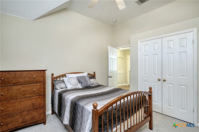 bedroom featuring visible vents, light carpet, a closet, ceiling fan, and vaulted ceiling