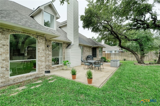 exterior space with a patio and fence