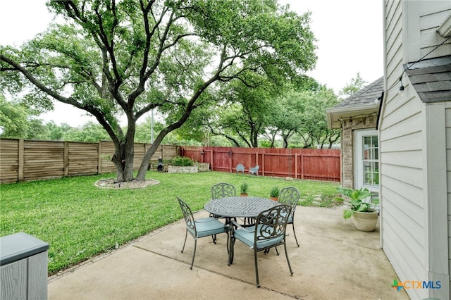 view of patio featuring outdoor dining space and a fenced backyard