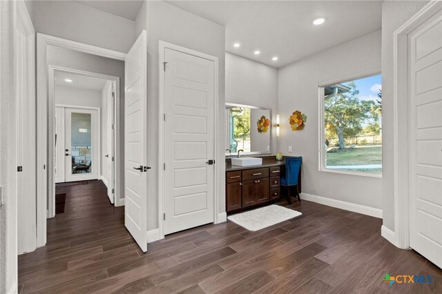 bedroom with a tray ceiling, wood walls, and multiple windows