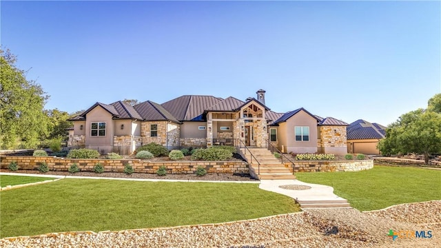 view of front of house with metal roof, stone siding, stucco siding, a front lawn, and a standing seam roof