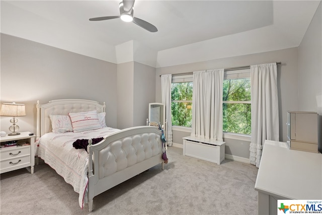 carpeted bedroom with ceiling fan, vaulted ceiling, and baseboards