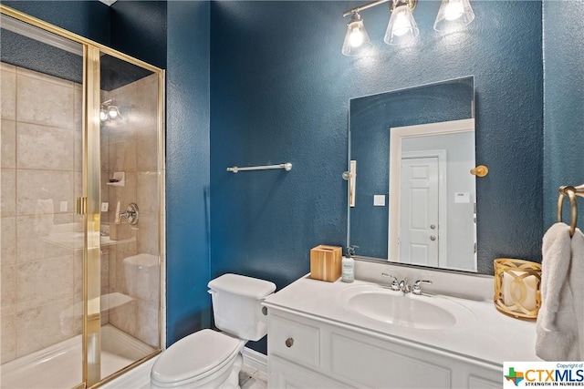 445 Champions Dr, Georgetown, TX 78628 - bathroom with baseboards, a shower stall, toilet, a textured wall, and vanity
