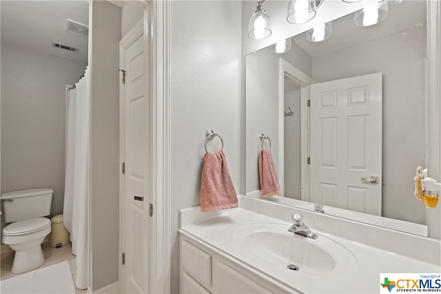 bathroom featuring tile patterned flooring, visible vents, vanity, and toilet