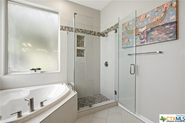 445 Champions Dr, Georgetown, TX 78628 - bathroom featuring a stall shower, a garden tub, and tile patterned flooring