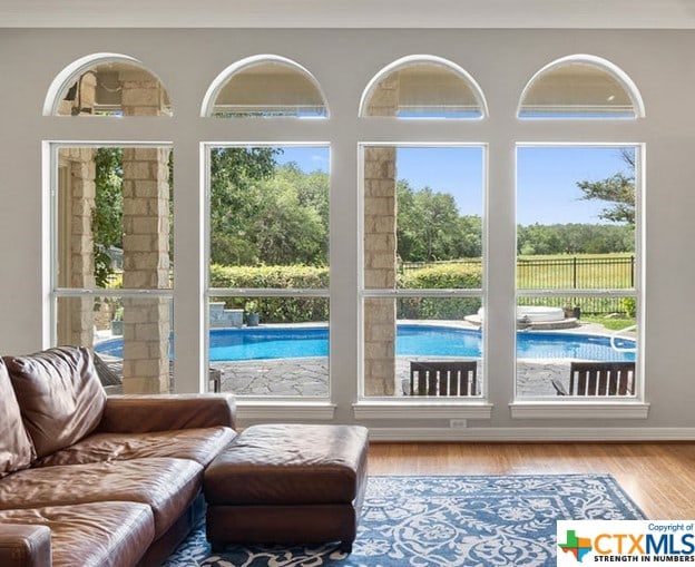 doorway featuring plenty of natural light, crown molding, and wood finished floors