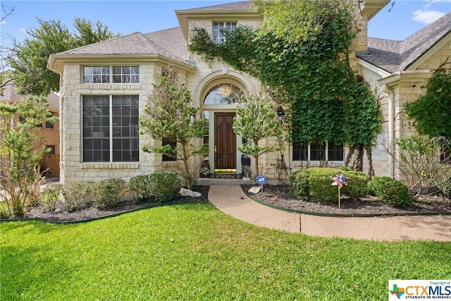 445 Champions Dr, Georgetown, TX 78628 - view of front of home featuring a front lawn, stone siding, and roof with shingles