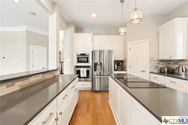 445 Champions Dr, Georgetown, TX 78628 - kitchen featuring appliances with stainless steel finishes, dark countertops, tasteful backsplash, white cabinetry, and recessed lighting