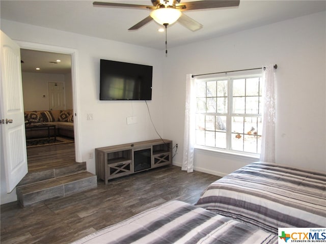 bedroom with dark wood-type flooring and ceiling fan