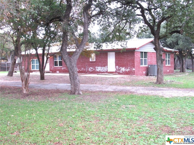 single story home with central air condition unit and a front lawn