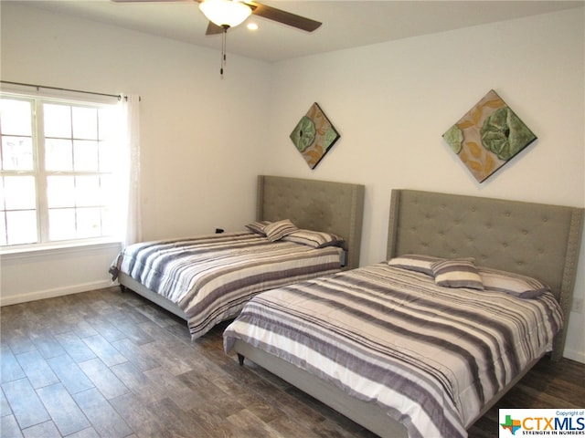 bedroom with dark wood-type flooring and ceiling fan