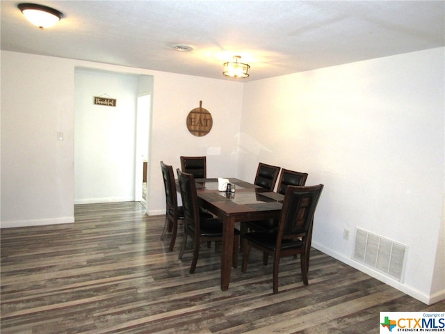 dining space with dark hardwood / wood-style flooring