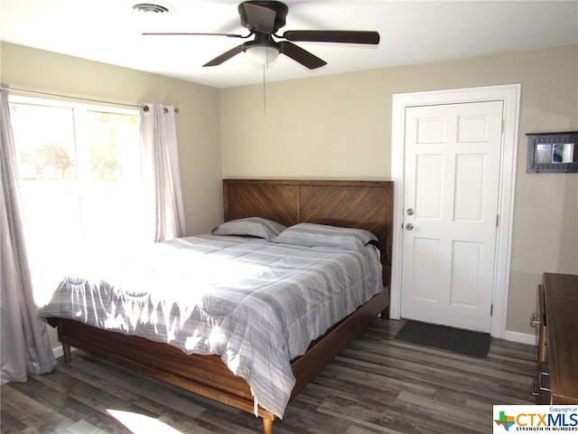 bedroom with dark wood-type flooring and ceiling fan