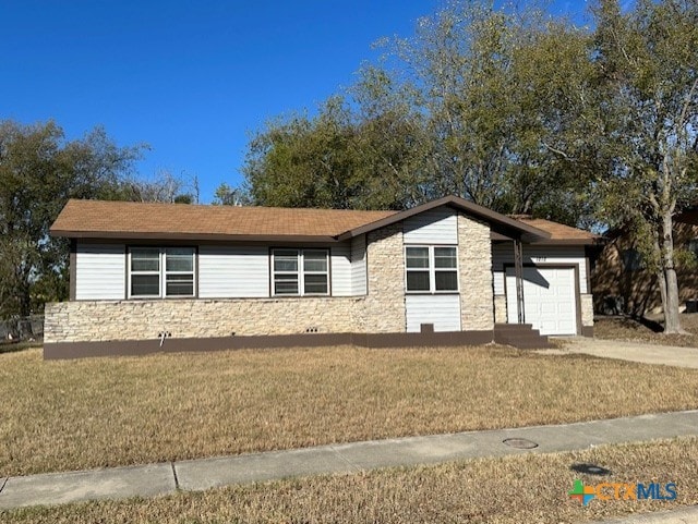 single story home featuring a garage and a front lawn