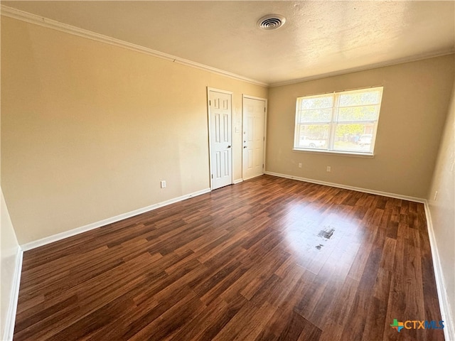 unfurnished bedroom featuring a textured ceiling, dark hardwood / wood-style floors, and crown molding