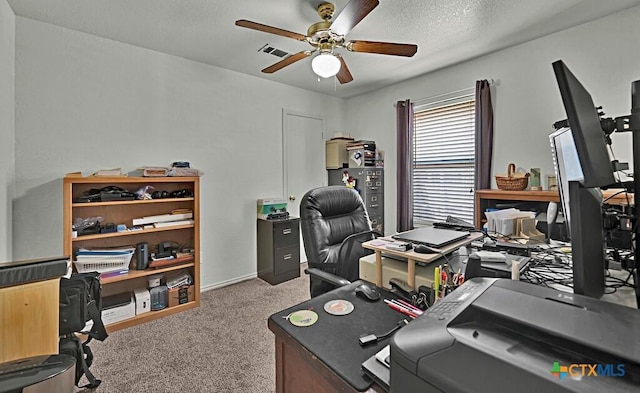 office featuring carpet, baseboards, visible vents, ceiling fan, and a textured ceiling