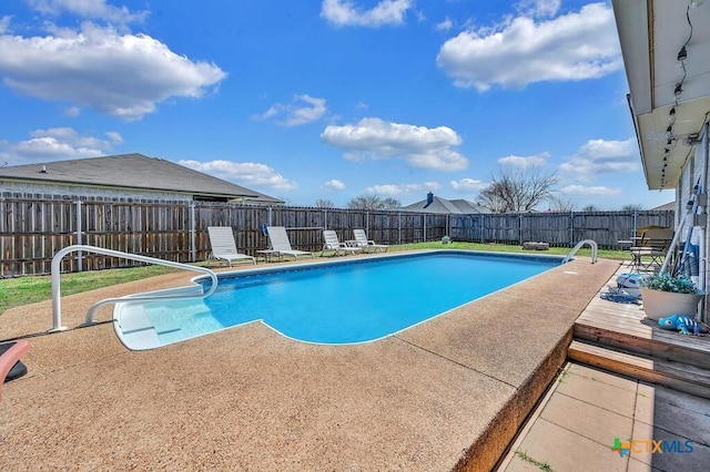 view of swimming pool featuring a patio area, a fenced backyard, and a fenced in pool