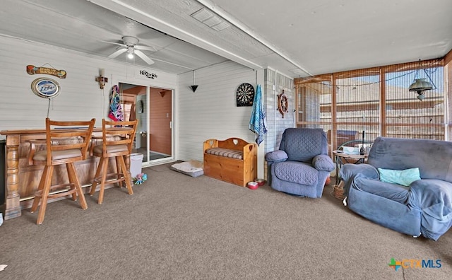 sunroom with a dry bar and a ceiling fan