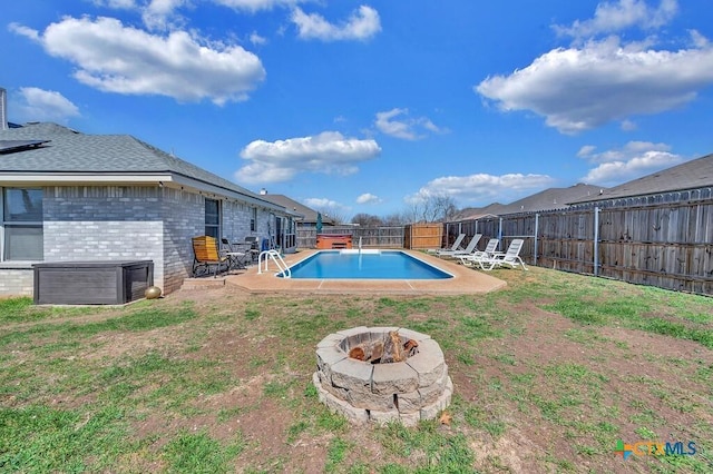 view of swimming pool featuring a fenced in pool, a fire pit, a lawn, and a fenced backyard