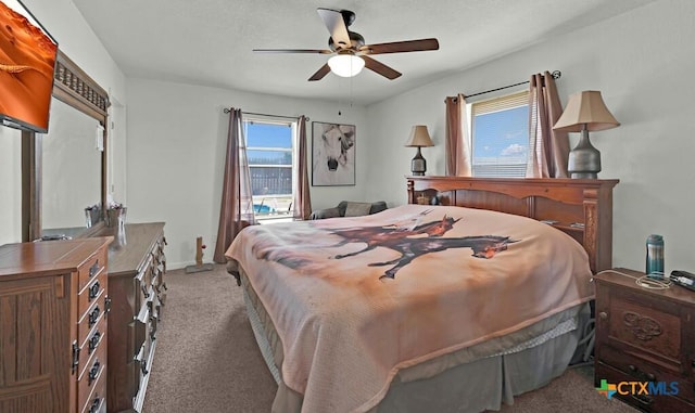 carpeted bedroom with baseboards and ceiling fan