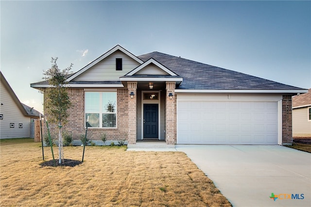 view of front of property featuring a garage and a front lawn