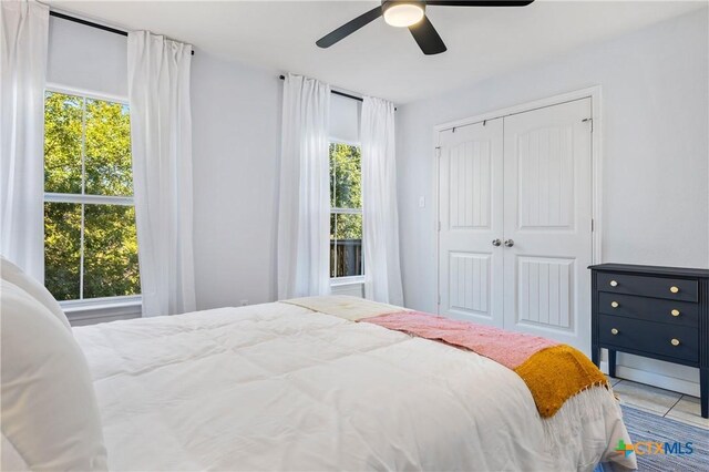 5445 Chimney Rock, Canyon Lake, TX 78133 - bedroom with ceiling fan, a closet, and multiple windows