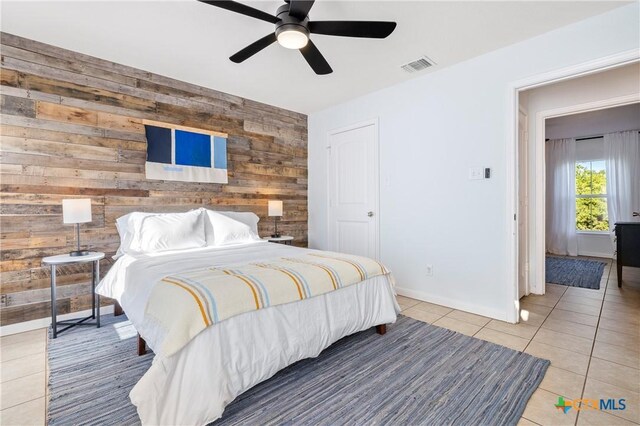 5445 Chimney Rock, Canyon Lake, TX 78133 - tiled bedroom with ceiling fan and wood walls