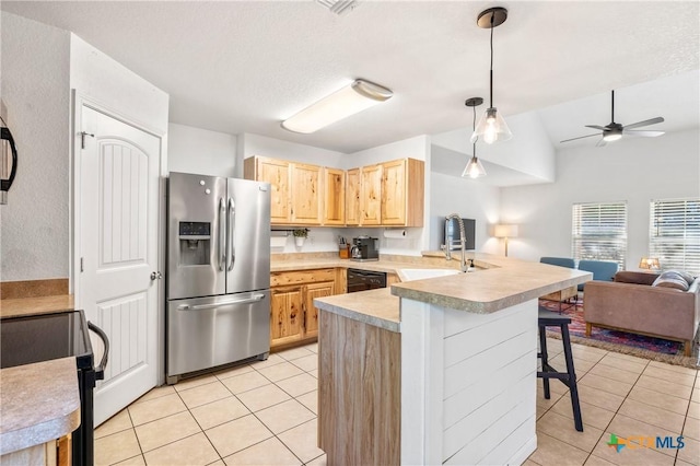 5445 Chimney Rock, Canyon Lake, TX 78133 - kitchen with a breakfast bar, decorative light fixtures, black appliances, kitchen peninsula, and light brown cabinets