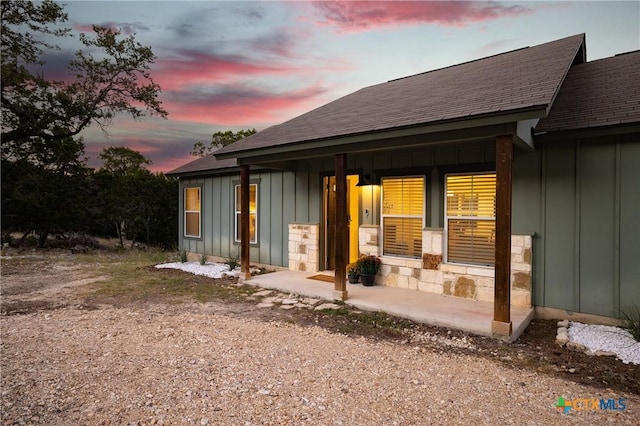 view of back house at dusk