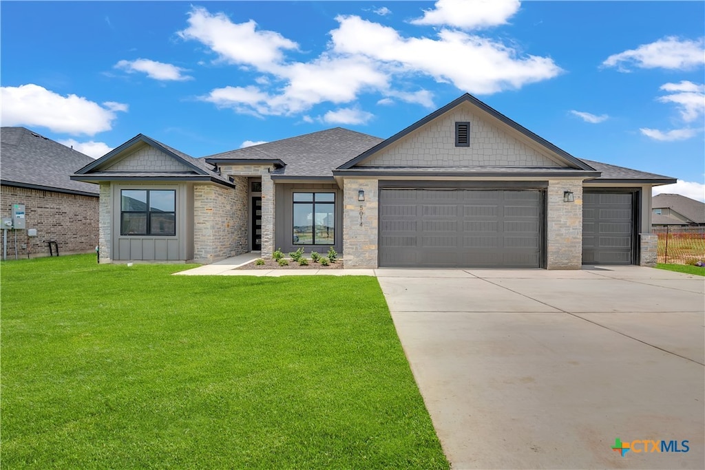 view of front facade with a front lawn and a garage