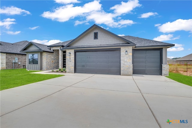 ranch-style house featuring a front lawn and a garage