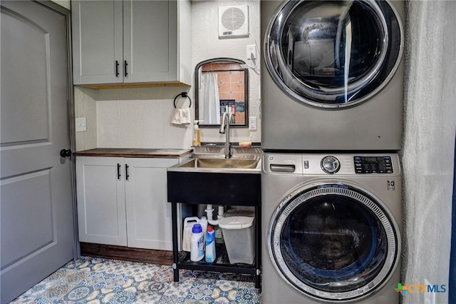 1319 County Road 339, Shiner, TX 77984 - laundry area with stacked washer and clothes dryer and cabinet space