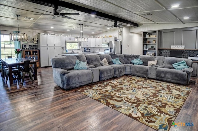 1319 County Road 339, Shiner, TX 77984 - living room with a chandelier, ceiling fan, plenty of natural light, recessed lighting, and beamed ceiling