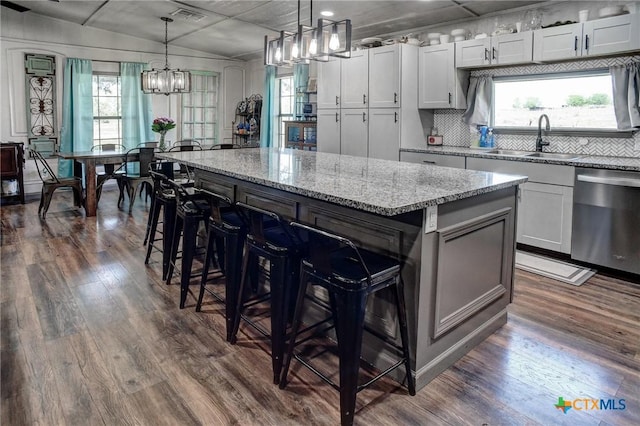 1319 County Road 339, Shiner, TX 77984 - kitchen featuring stainless steel dishwasher, a sink, dark wood-style floors, and a center island