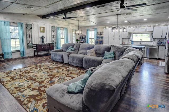 1319 County Road 339, Shiner, TX 77984 - living room featuring a ceiling fan, a chandelier, dark wood-style floors, recessed lighting, and beam ceiling